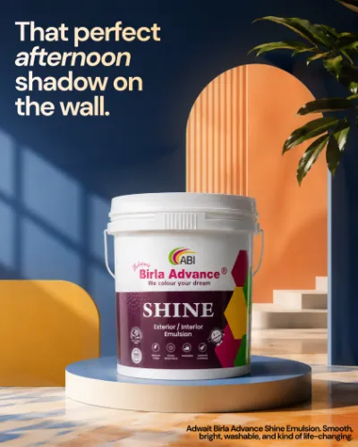 ABI post: “That perfect afternoon shadow on the wall.” A Birla Advance Shine pack on a round plinth against blue and orange walls.
